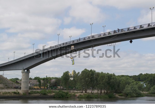 Ukraine, Chernigov, June 30, 2013: Extreme City\
Extreme Sports Festival. Rope jumping, a man jumps from a bridge,\
jump from a bridge with a\
rope