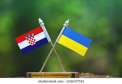 Ukraine And Croatia Small Flag With Blur Green Background