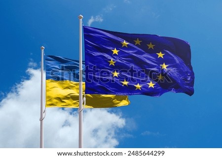 Ukraine and EU flags above blue sky. Ukraine path towards Europe Union