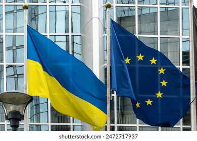 Ukraine and European union flags in front of the European Parliament buildings in Brussels. Representing the unity and support between Ukraine and the EU, especially in the context of the ongoing - Powered by Shutterstock