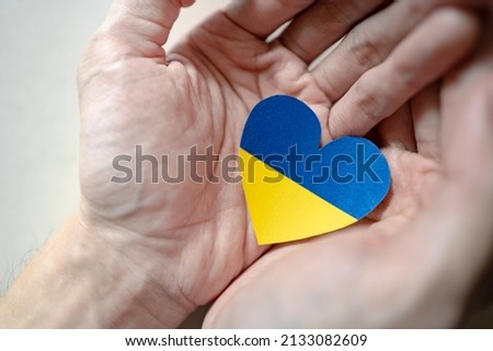 Ukraine flag color heart in hands