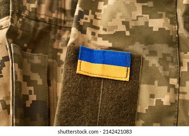 Ukraine flag and military uniform of ukrainian soldier. Armed Forces of Ukraine