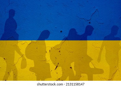 Ukraine flag on wall and refugee shadows. Ukraine war concept. - Shutterstock ID 2131158147