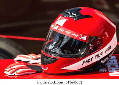 Ukraine, Kiev -  August 15, 2015: Red Ferrari Helmet With Gloves For Riding On A Racing Car F1