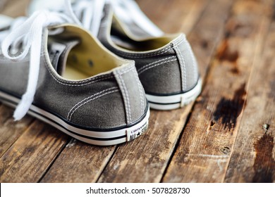  Ukraine, Kiev, October 30, 2016: Crey Converse Shoes On Wooden Planks. 
Crey Sneakers On Wooden Background With Copy Space. Top View. Sneakers On Wooden Deck.
