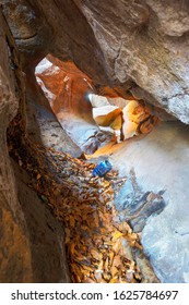 Ukraine, Kosiv, January 18, 2020: In The Carpathians Are Located Leaky Rock And Hawkeye Rocks. A Cave In A Stone Massif Amid A Beech Forest, Uncultured Tourists Leave Beer Cans In It.