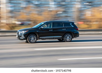 Ukraine, Kyiv - 11 March 2021: Black Infiniti QX60 car moving on the street;