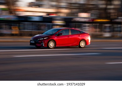 Ukraine, Kyiv - 11 March 2021: Red Toyota Prius Car Moving On The Street;