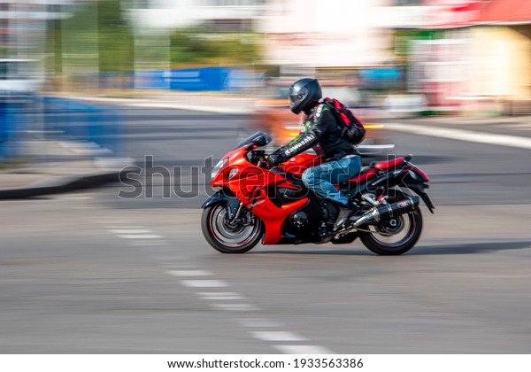 Ukraine, Kyiv - 28 September 2020: Red Kawasaki\
motorcycle moving on the\
street