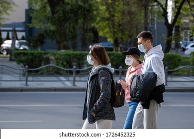 UKRAINE, KYIV - April 25, 2020: Group Of People Walks On A Street Wearing A Medical Masks To Prevent Of Bacterial Infection Corona Virus Or Covid 19 Epidemic On Street.