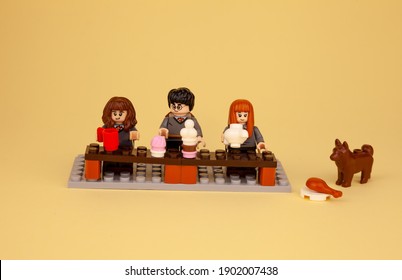 Ukraine, Kyiv - April 3, 2020: Lego Figures Stay At Home And Drink From Glasses. Harry Potter Little Men Sit And Eat. Date, Love, Celebrate