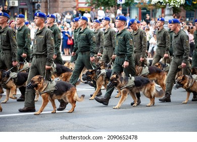 Ukraine, Kyiv - August 18, 2020: Border guards with shepherd dogs. The military at the parade. A soldier with a watchdog. Service dog shepherd in the service of the state. The soldiers are marching.