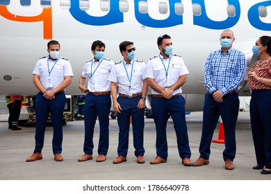 Ukraine, Kyiv - July 8, 2020: The pilot, captain and flight attendant are personnel, a team in medical masks. Masked people at work. Flydubai Airlines A6-FEP. Boryspil International Airport.