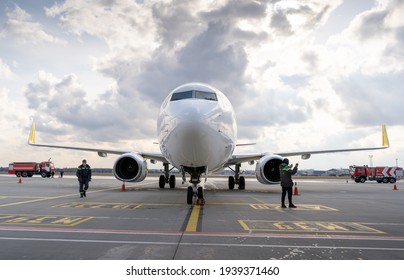 Ukraine, Kyiv - March 19, 2021: Bees Airline plane on the apron. Boeing 737-800 UR-UBA Passenger aircraft. Airport. New plane with firetruck. Cloudy day for travel. Runway