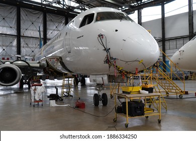 Ukraine, Kyiv - November 25, 2020: The Embraer E190LR UR-EMD Aircraft Is In The Hangar For Technical Repair And Maintenance. Aircraft Diagnostics, Storage, Service. Plane. Ladders For Mechanics