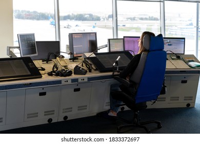 Ukraine, Kyiv - October 10, 2020: The Air Traffic Controller At The Airport Manages The Takeoff And Landing Of Aircraft. Control Tower Inside. Flight Workstation. The Woman Looks Into The Monitors