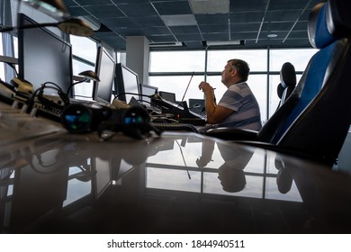 Ukraine, Kyiv - October 10, 2020: The Air Traffic Controller At The Airport Manages The Takeoff And Landing Of Aircraft. Control Tower Inside. Flight Workstation. The Man Looks Into The Monitors.