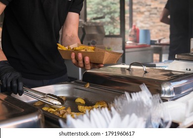 UKRAINE, LUTSK - May 20, 2019: Baked potatoes fried whole in a paper box in the park at the festival. - Shutterstock ID 1791960617