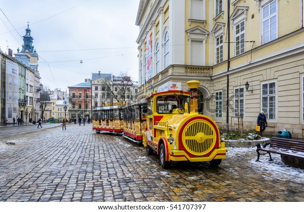 Ukraine, Lviv - December, 15,\
2016: Sightseeing road train in the Rynok Square next to Lviv city\
council expects tourists for a sightseeing tour of the city of\
Lviv.