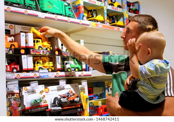 Ukraine, Odessa,\
July 2019, Epicenter Shopping Center, toy store, department with\
toy cars, dad and son choose\
toys.
