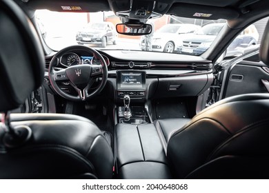 Ukraine, Odessa September 8 - 2021: Interior Of Modern Luxury Car Maserati Ghibli. Car Interior With Big Display Navigation Unit, Automatic Transmission, No People. Photo Taken From The Back Seat.