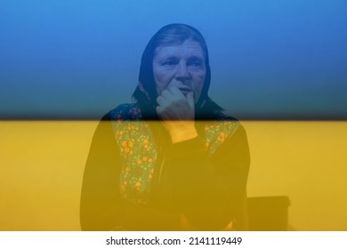 Ukraine Senior Farmer. Defocus Portrait Of 60s Russian Grandmother Senior Old Woman Seating Indoors. Old Women In Shawl. Sad Thinking Person Close-up. White Dirty Background. Out Of Focus.