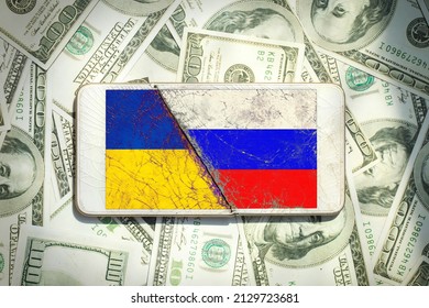 Ukraine vs Russia national flags icon pattern on the broken phone screen on a $100 dollar bill background.Ukraine US Russia politics economy relationship conflict.inflation