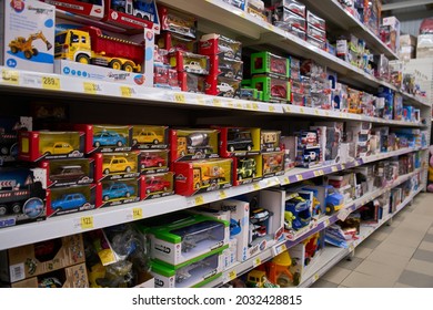 Ukraine,Dnepropetrovsk.05.06.2021Shelf With Many Colored Toys. Blurred Of Kids Toy Store Background. Variety Of Construction Toys On Shelves In A Store.Toy Colored Plastic Cars In The Children's Store