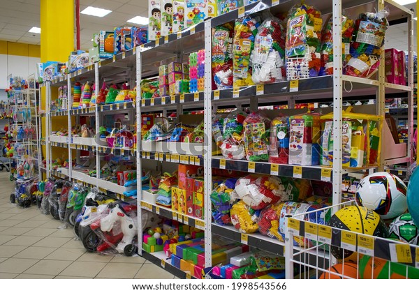 Ukraine,Dnepropetrovsk.05.06.2021Shelf with many\
colored toys. Blurred of kids toy store background. Variety of\
construction toys on shelves in a store.Toy colored plastic cars in\
the children\'s\
store