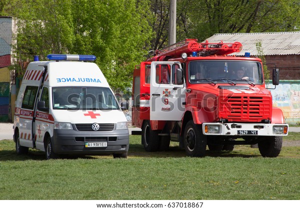 A Ukrainian ambulance and a fire\
truck. Stadium \