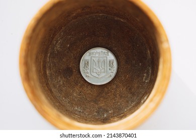 Ukrainian Coin At The Bottom Of A Wooden Box In A Piggy Bank On A White Background