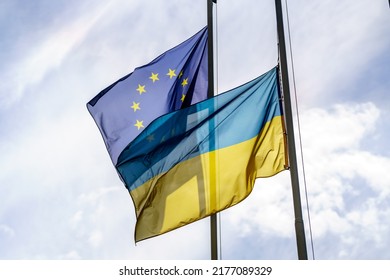 Ukrainian and European Union flags on masts - Shutterstock ID 2177089329