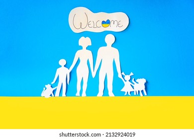 ukrainian families are welcome with their children and pets. paper cutout on the colors of the flag of ukraine. war exodus.  people abandoning their homes