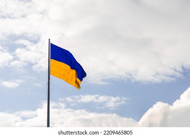 Ukrainian flag blowing on a wind bright sky background simple wallpaper advertising copy space concept 