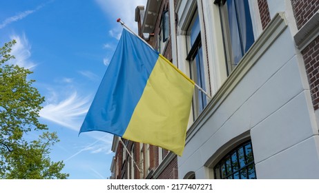 A Ukrainian Flag Hanging In The City Centre Of Leiden. Leiden Is A Dutch City Nearby Amsterdam, Netherlands. The Flag Is To Show Support To The People Of Ukraine In The War Against Russia.