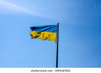 Ukrainian flag in the wind. Against the background of the sky 