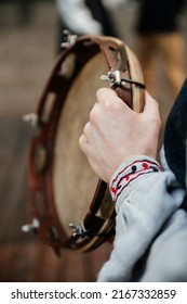 Ukrainian Folk Music, Traditional National Costume Close-up: Man's Hand In An Embroidered Shirt Linen Fabric Holds A Wooden Tambourine