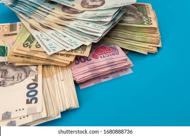 Ukrainian hryvnia money new bills 1000 and 500 isolated on blue. Stack of money. UAH - Shutterstock ID 1680888736