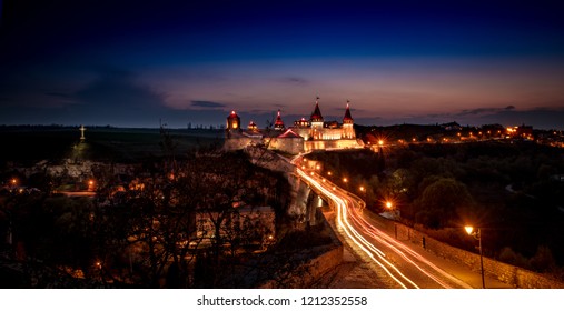 Ukrainian Kamianets-Podilskyi fortress at sunset with beautiful view, city and cobblestone road