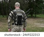 Ukrainian military with anti-drone backpack. WB, radio-electronic warfare.