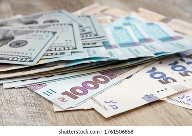 Ukrainian Money - Hryvnia Banknotes USA Dollars Bills. Finance In Ukraine, Of The Hryvnia To The Dollar Exchange Rate. Multi Currency Money Dollars And Hryvnia, Close-up Concept Finance Investment.