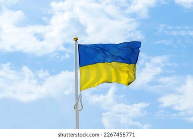Ukrainian national blue and yellow colors flag waving in the wind against blue sky.Ukraine National government patriotic symbol,Independence,Constitution day.