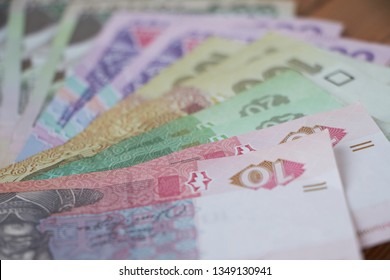 Ukrainian national currency, bills of different values, the calculation between people, the transfer of money, wood background. - Shutterstock ID 1349130941