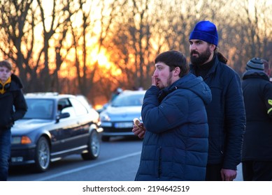 Ukrainian Orthodox Priests Watch Over A Car Convoy Of Refugees. Sunset. Second Day Of The Russian Invasion. Palanka, Odessa Region, Ukraine. February 25, 2022.