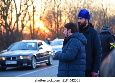 Ukrainian Orthodox Priests Watch Over A Car Convoy Of Refugees. Sunset. Second Day Of The Russian Invasion. Palanka, Odessa Region, Ukraine. February 25, 2022.