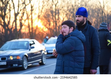 Ukrainian Orthodox Priests Watch Over A Car Convoy Of Refugees. Sunset. Second Day Of The Russian Invasion. Palanka, Odessa Region, Ukraine. February 25, 2022.