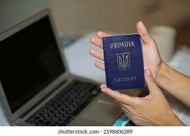 Ukrainian Passport In Hand Near The Computer