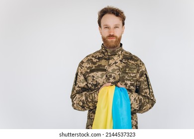 Ukrainian Patriot Soldier In Military Uniform Holding A Yellow And Blue Flag On A White Background