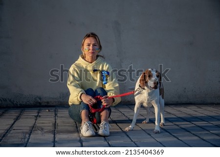 Similar – Portrait of a young, tall woman behind a blond Labrador