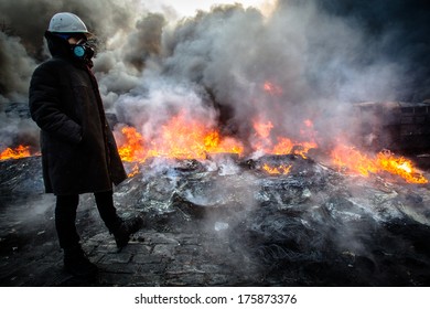 Ukrainian revolutionary standing near the fire in the street Hrushevskoho. Ukraine, Kiev on January 23, 2014. - Shutterstock ID 175873376